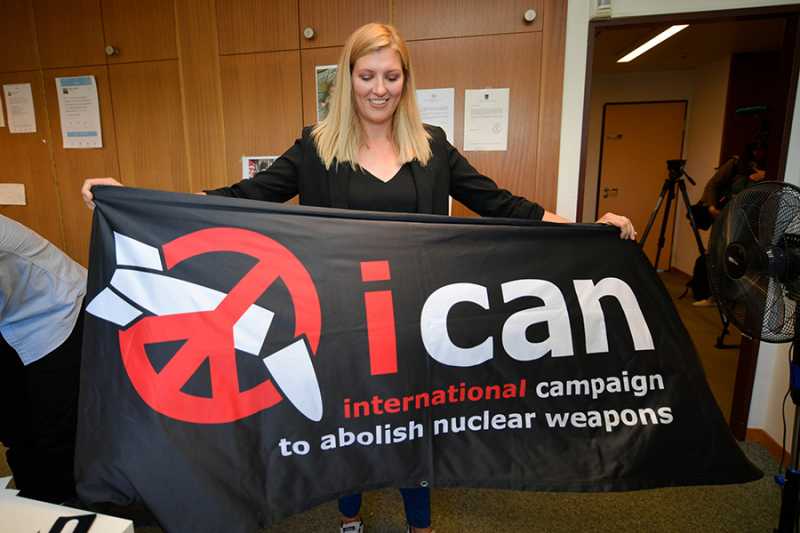 Beatrice Fihn, executive director of the International Campaign to Abolish Nuclear Weapons (ICAN) displays the group’s banner October 6 in Geneva after it won the 2017 Nobel Peace Prize. (Photo credit: FABRICE COFFRINI/AFP/Getty Images)